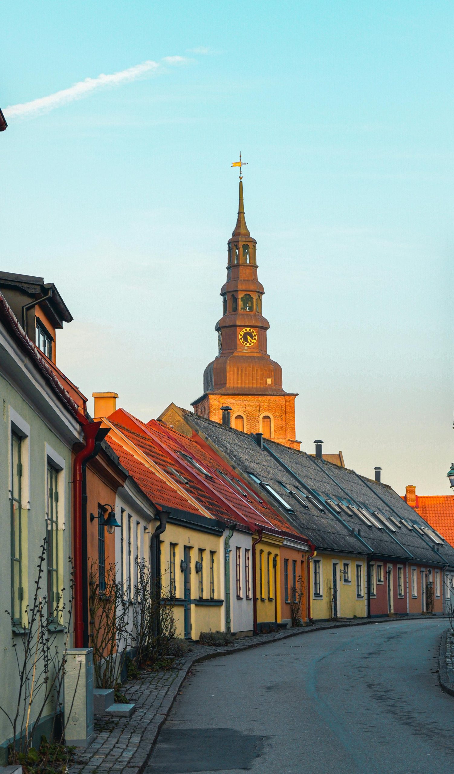 Charming streets of Ystad, Sweden with colorful buildings and a historic church.